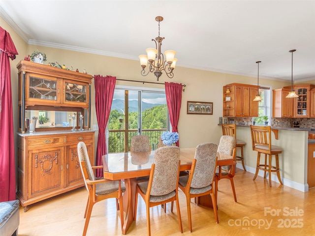 80 Feather Ln, Waynesville, NC 28786 - dining space with crown molding, light wood-type flooring, and a chandelier