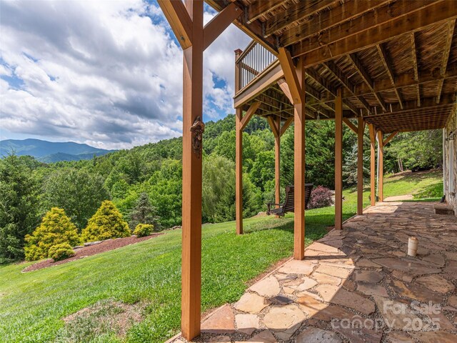 80 Feather Ln, Waynesville, NC 28786 - view of grassy yard featuring a patio, a wooded view, and a deck with mountain view
