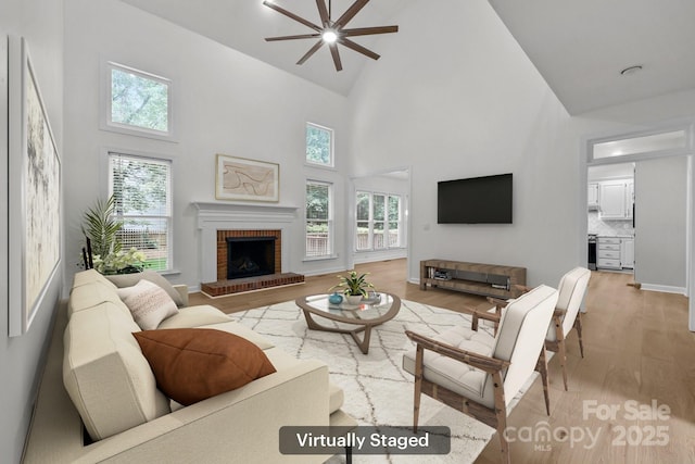 15400 Groveland St, Huntersville, NC 28078 - living room with high vaulted ceiling, a ceiling fan, a fireplace, light wood-style flooring, and plenty of natural light