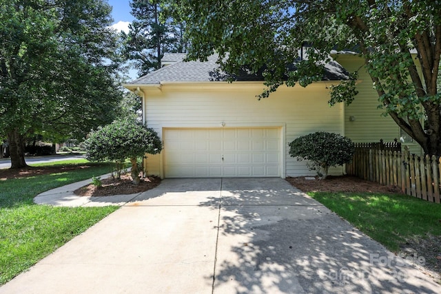 15400 Groveland St, Huntersville, NC 28078 - view of side of property with concrete driveway, a shingled roof, and a garage