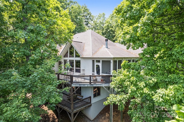 102 Coyote Rdg, Maggie Valley, NC 28751 - rear view of property featuring a deck, a sunroom, and a shingled roof