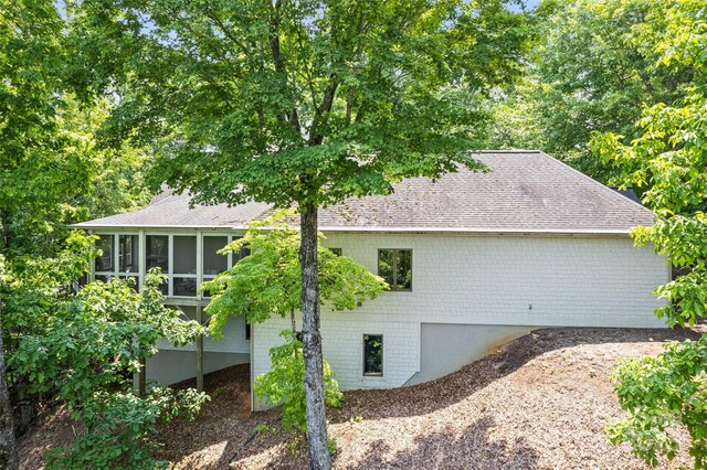 102 Coyote Rdg, Maggie Valley, NC 28751 - view of property exterior featuring roof with shingles and a sunroom