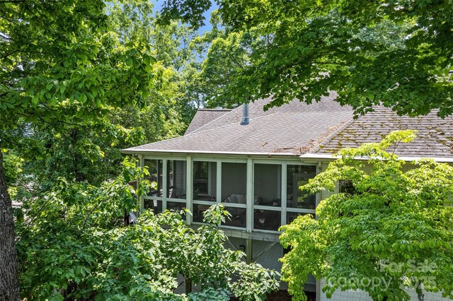 102 Coyote Rdg, Maggie Valley, NC 28751 - view of home's exterior featuring roof with shingles and a sunroom