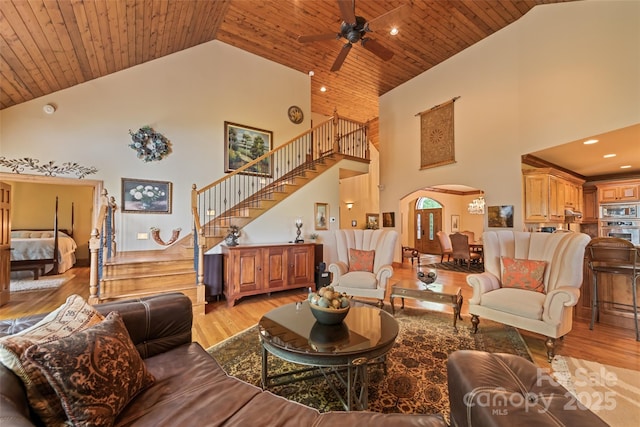 102 Coyote Rdg, Maggie Valley, NC 28751 - living area with high vaulted ceiling, arched walkways, stairs, light wood-style flooring, and ceiling fan