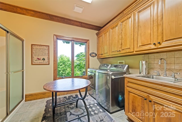102 Coyote Rdg, Maggie Valley, NC 28751 - laundry room featuring washer and dryer, cabinet space, ornamental molding, and light tile patterned flooring