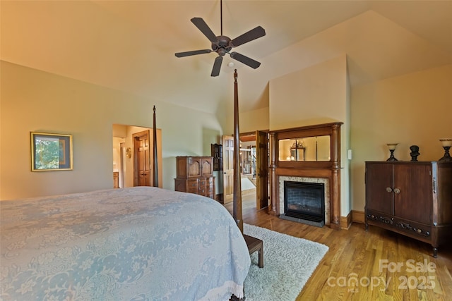 102 Coyote Rdg, Maggie Valley, NC 28751 - bedroom featuring a glass covered fireplace, wood finished floors, lofted ceiling, and ceiling fan