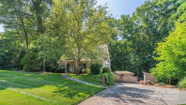 333 Garden Valley Dr, Winston Salem, NC 27107 - view of property hidden behind natural elements featuring concrete driveway and a front yard