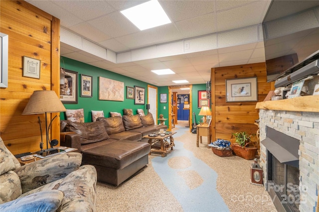 333 Garden Valley Dr, Winston Salem, NC 27107 - living area with a paneled ceiling, wooden walls, and a stone fireplace