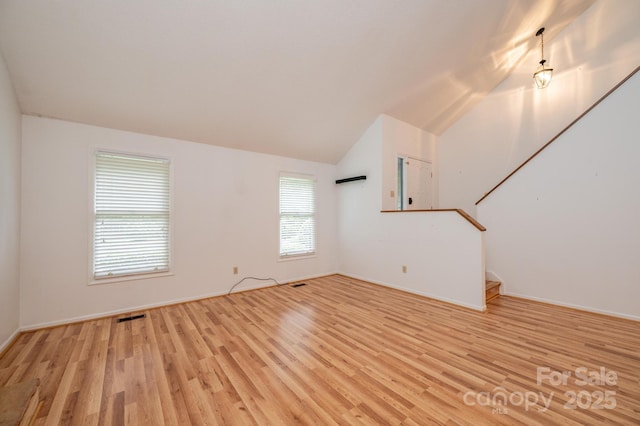 3221 5th Street Ct NW, Hickory, NC 28601 - unfurnished living room with light wood finished floors, stairs, vaulted ceiling, and baseboards
