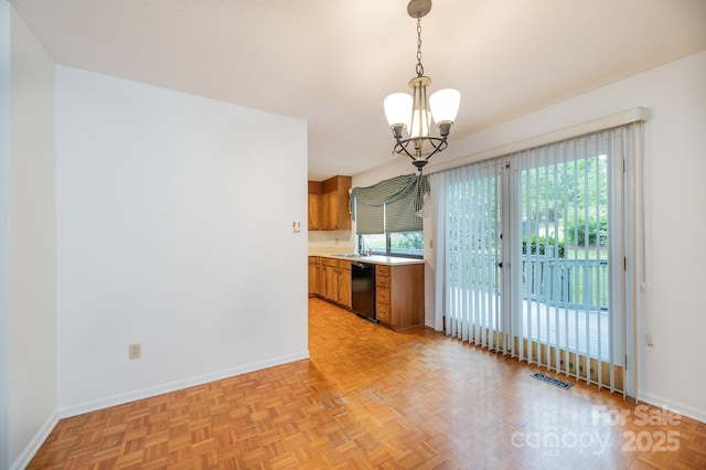3221 5th Street Ct NW, Hickory, NC 28601 - kitchen with black dishwasher, brown cabinetry, light countertops, a chandelier, and pendant lighting