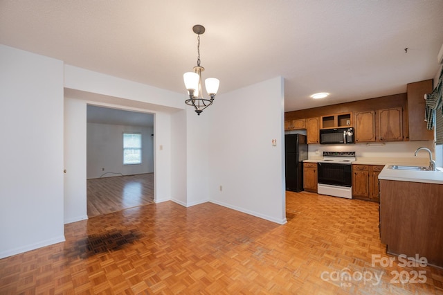 3221 5th Street Ct NW, Hickory, NC 28601 - kitchen featuring black appliances, a sink, light countertops, a chandelier, and baseboards