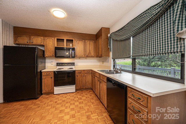 3221 5th Street Ct NW, Hickory, NC 28601 - kitchen with black appliances, a textured ceiling, brown cabinets, light countertops, and open shelves