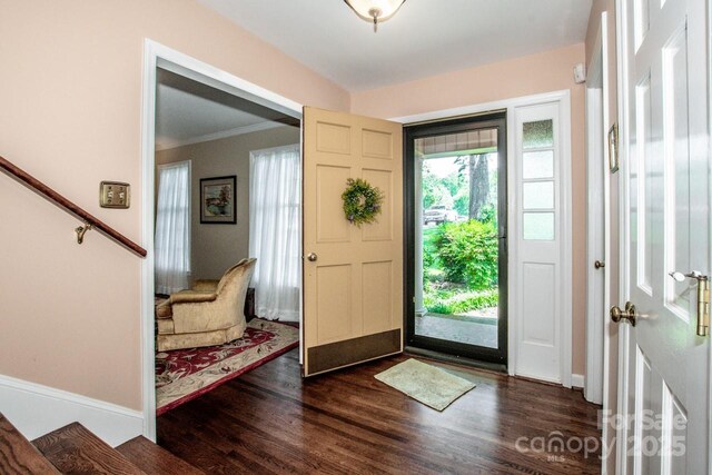 928 Tally Ho Ct, Charlotte, NC 28212 - entrance foyer with dark wood-type flooring, crown molding, and stairway