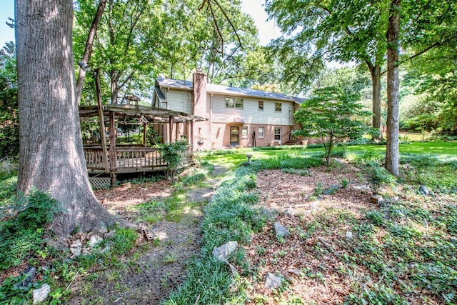 928 Tally Ho Ct, Charlotte, NC 28212 - back of property featuring a deck, a pergola, a chimney, brick siding, and a lawn