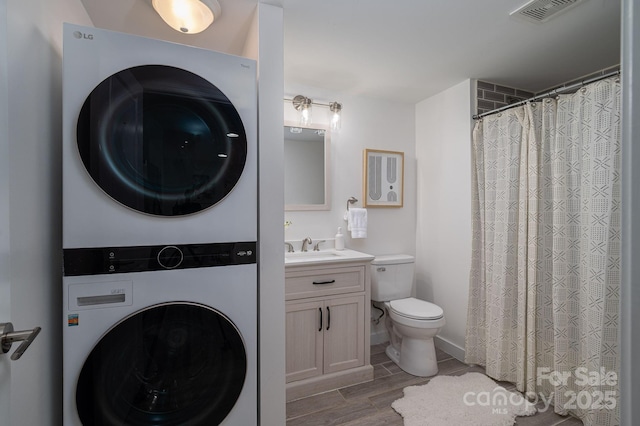 1212 Frank Ext, Rock Hill, SC 29730 - full bathroom featuring stacked washer / dryer, wood finished floors, toilet, vanity, and a shower with shower curtain
