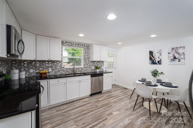 1212 Frank Ext, Rock Hill, SC 29730 - kitchen featuring stainless steel dishwasher, a sink, range, light wood-style floors, and backsplash