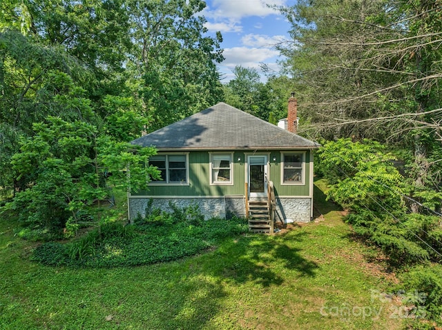 14 Luckenbach Dr, Fairview, NC 28730 - bungalow-style house with a chimney, a front yard, and a shingled roof