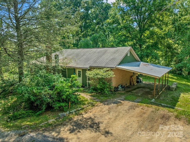 14 Luckenbach Dr, Fairview, NC 28730 - view of front of house with dirt driveway, a carport, and stucco siding