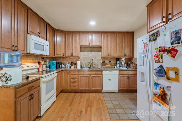 14 Luckenbach Dr, Fairview, NC 28730 - kitchen featuring white appliances, a sink, decorative backsplash, light stone counters, and brown cabinetry