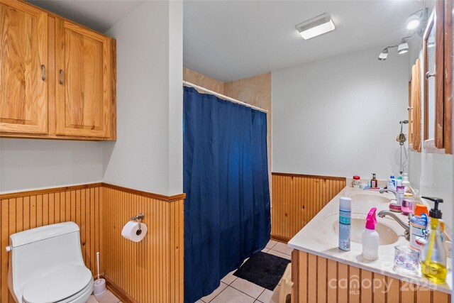 14 Luckenbach Dr, Fairview, NC 28730 - full bathroom with a wainscoted wall, toilet, double vanity, tile patterned flooring, and curtained shower