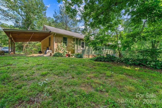 14 Luckenbach Dr, Fairview, NC 28730 - view of green lawn featuring a carport