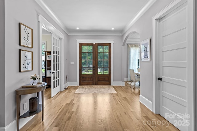 5638 Timber Ln, Charlotte, NC 28270 - foyer entrance with french doors, arched walkways, light wood-type flooring, baseboards, and crown molding