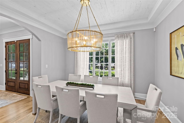 5638 Timber Ln, Charlotte, NC 28270 - dining room featuring arched walkways, wood finished floors, a chandelier, french doors, and a raised ceiling