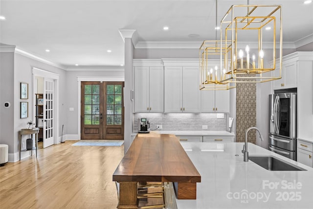 5638 Timber Ln, Charlotte, NC 28270 - kitchen with smart refrigerator, a sink, french doors, crown molding, and light countertops