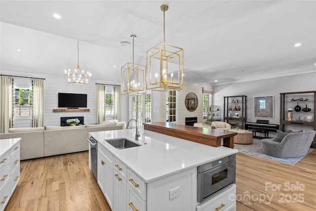 5638 Timber Ln, Charlotte, NC 28270 - kitchen featuring a fireplace, open floor plan, a sink, a chandelier, and recessed lighting