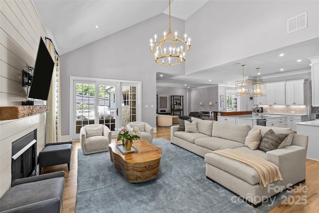 5638 Timber Ln, Charlotte, NC 28270 - living area with light wood finished floors, a fireplace, a chandelier, healthy amount of natural light, and high vaulted ceiling