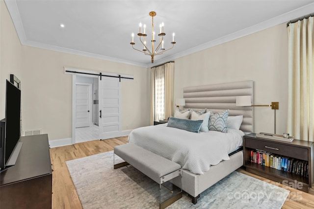 5638 Timber Ln, Charlotte, NC 28270 - bedroom with a barn door, wood finished floors, crown molding, a chandelier, and baseboards