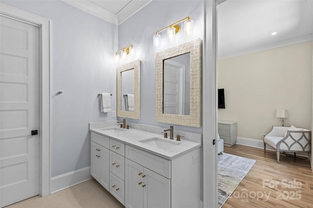 5638 Timber Ln, Charlotte, NC 28270 - bathroom with double vanity, baseboards, wood finished floors, and ornamental molding