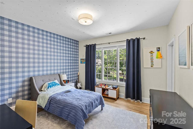 5638 Timber Ln, Charlotte, NC 28270 - bedroom featuring wallpapered walls, light wood-type flooring, and baseboards