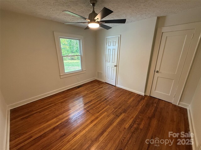 322 Buffalo St, Shelby, NC 28150 - unfurnished bedroom featuring wood finished floors, a textured ceiling, and ceiling fan