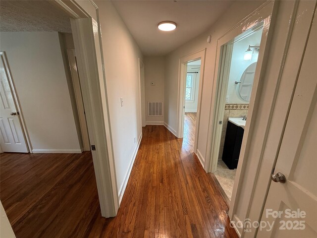 322 Buffalo St, Shelby, NC 28150 - corridor with dark wood-style flooring and baseboards