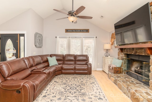 100 Donna Dr, Franklin, NC 28734 - living area with ceiling fan, light wood finished floors, high vaulted ceiling, and a stone fireplace