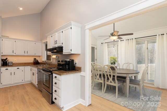 100 Donna Dr, Franklin, NC 28734 - kitchen featuring stainless steel electric range oven, a sink, light wood finished floors, white cabinetry, and high vaulted ceiling