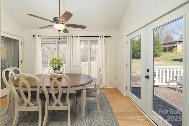 100 Donna Dr, Franklin, NC 28734 - dining space with vaulted ceiling, ceiling fan, light wood-style floors, healthy amount of natural light, and wood walls