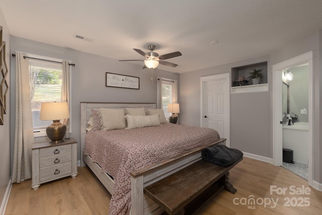 100 Donna Dr, Franklin, NC 28734 - bedroom with baseboard heating, light wood-style flooring, baseboards, and a ceiling fan