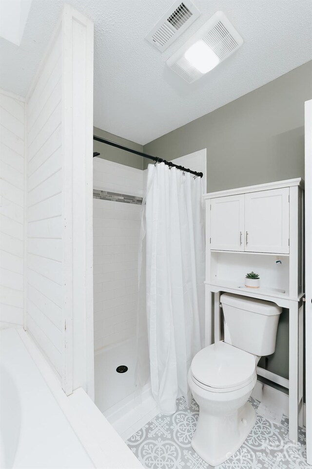 100 Donna Dr, Franklin, NC 28734 - bathroom featuring toilet, a shower stall, and tile patterned flooring