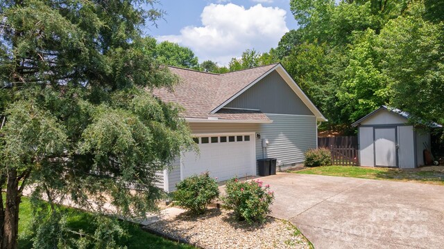 100 Donna Dr, Franklin, NC 28734 - view of side of home with roof with shingles, driveway, and an attached garage
