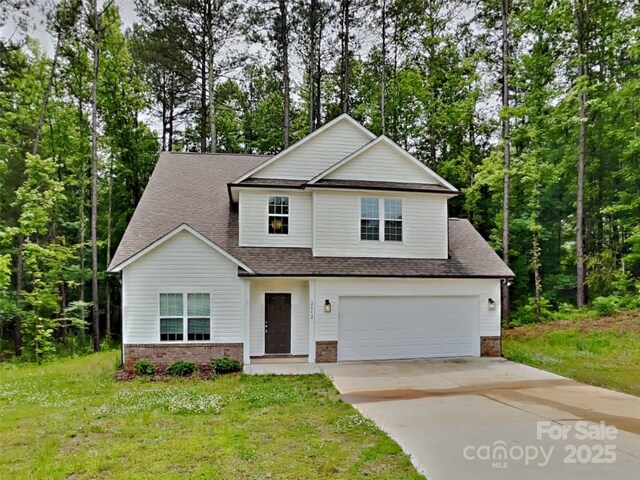 2612 Cold Springs Rd, Concord, NC 28025 - traditional-style house featuring brick siding, driveway, a front lawn, a shingled roof, and a garage