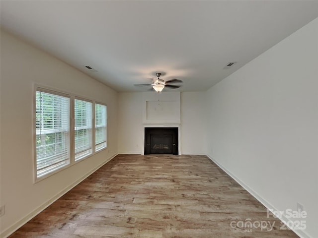 2612 Cold Springs Rd, Concord, NC 28025 - unfurnished living room with ceiling fan, light wood-type flooring, a fireplace, and baseboards