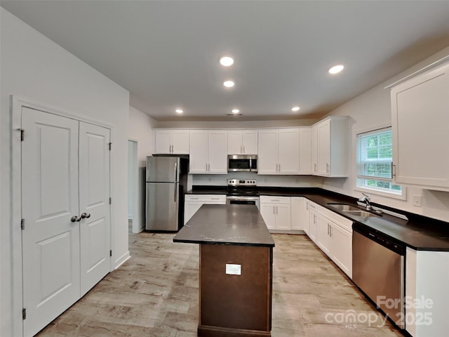 2612 Cold Springs Rd, Concord, NC 28025 - kitchen featuring stainless steel appliances, dark countertops, light wood-style flooring, a center island, and recessed lighting