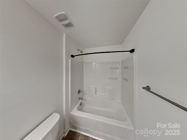 2612 Cold Springs Rd, Concord, NC 28025 - bathroom featuring toilet, shower / washtub combination, baseboards, and wood finished floors