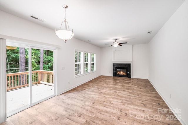 2612 Cold Springs Rd, Concord, NC 28025 - unfurnished living room featuring light wood-style flooring, ceiling fan, and a high end fireplace