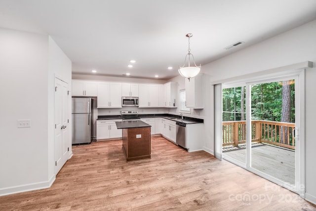 2612 Cold Springs Rd, Concord, NC 28025 - kitchen featuring appliances with stainless steel finishes, dark countertops, light wood-style flooring, white cabinetry, and recessed lighting