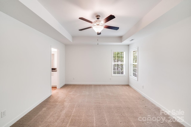 2612 Cold Springs Rd, Concord, NC 28025 - empty room featuring a ceiling fan, light carpet, and a tray ceiling