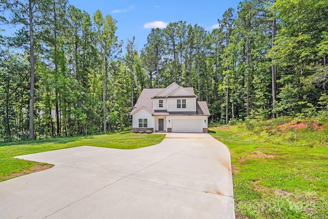 2612 Cold Springs Rd, Concord, NC 28025 - view of front of property with concrete driveway, an attached garage, a front yard, and a wooded view