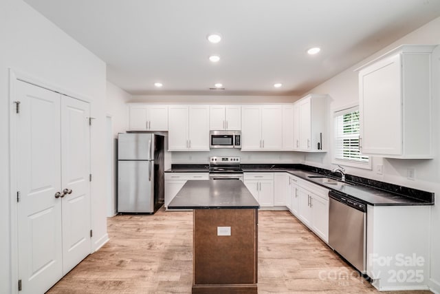2612 Cold Springs Rd, Concord, NC 28025 - kitchen featuring appliances with stainless steel finishes, dark countertops, white cabinetry, and recessed lighting